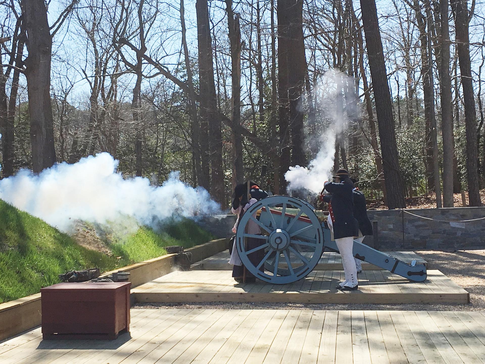 Historical interpreters fire artillery in the Continental Army encampment's artillery amphitheater. Demonstrations are held daily at 3 p.m.