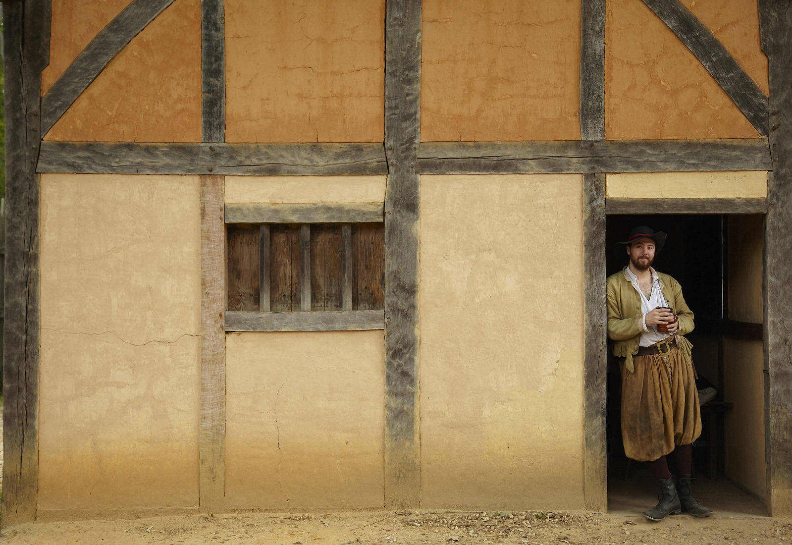 A man standing in a doorway at James Fort