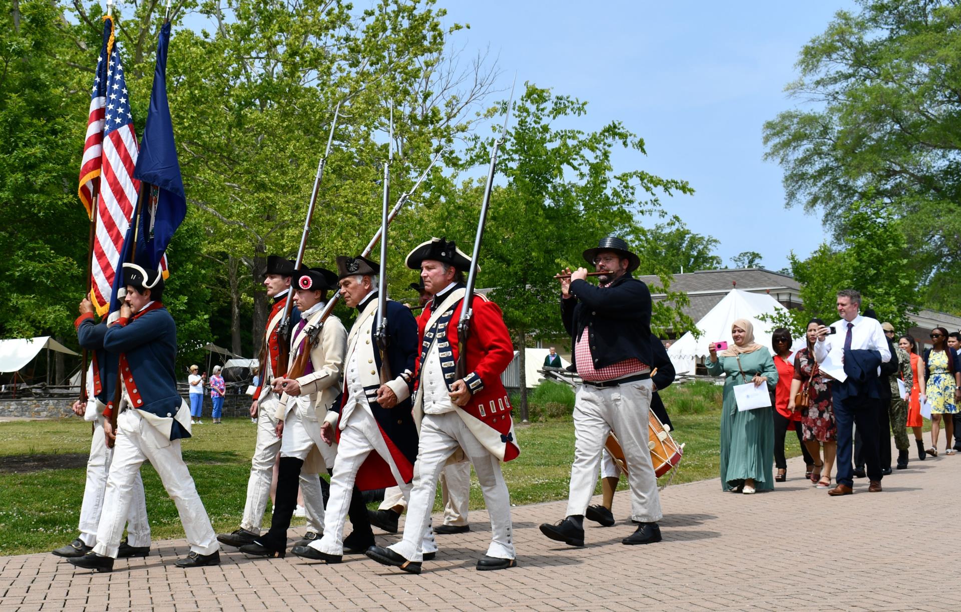 Naturalization candidates follow a Patriotic Procession at the American Revolution Museum at Yorktown