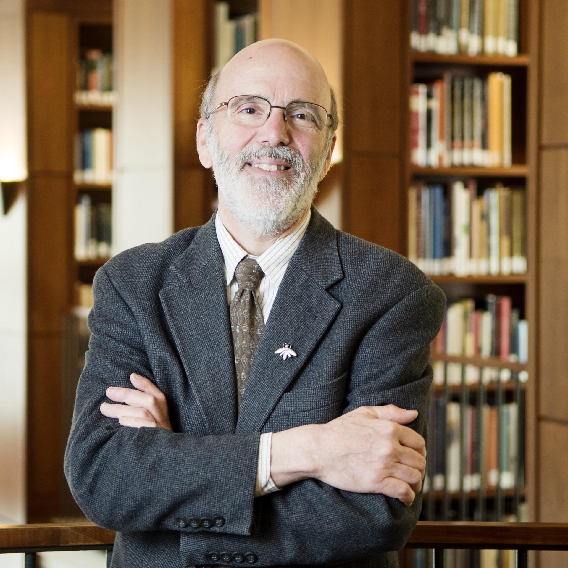 A portrait of John Ragosta in a library