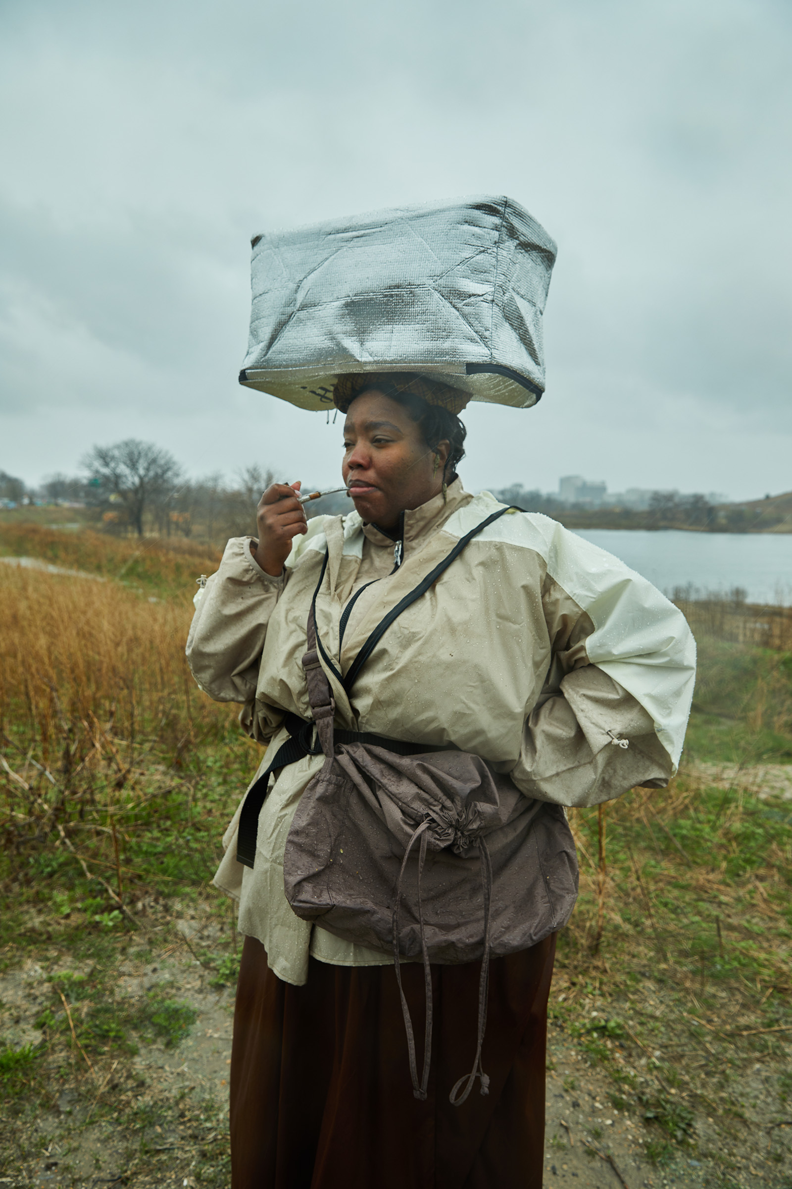 Cheyney McKnight stands in a field with a parcel on her head