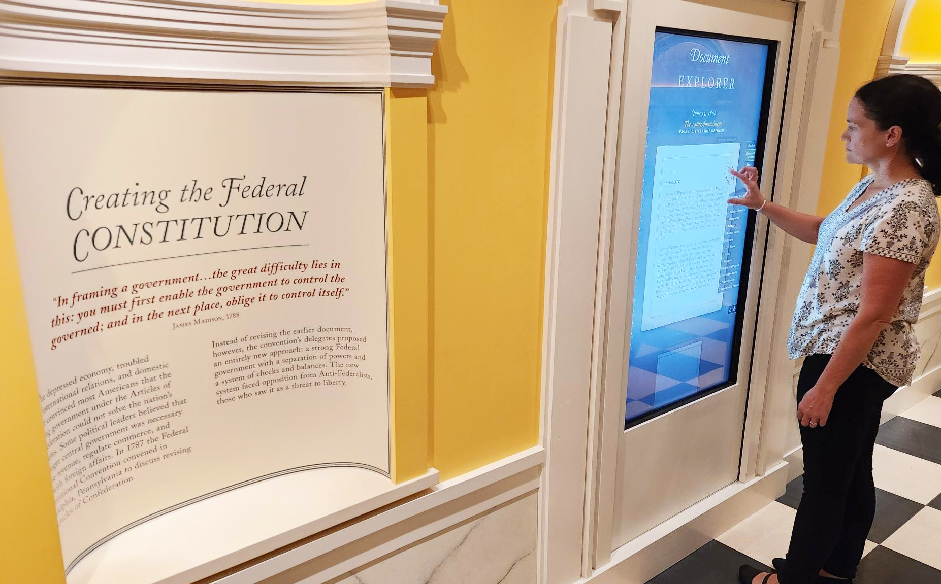 A visitor to the American Revolution Museum at Yorktown uses the Constitution interactive screen