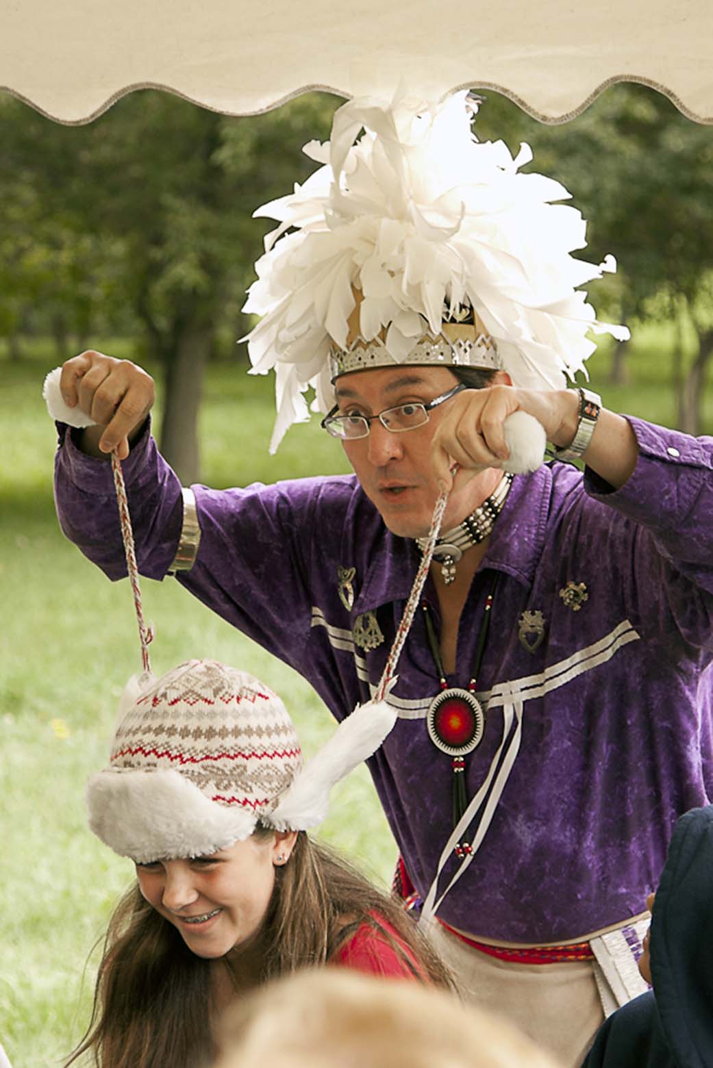 A photo of master storyteller Perry Ground with a laughing child