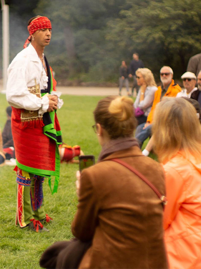 A cultural educator from the Shawnee Nation speaks to museum visitors