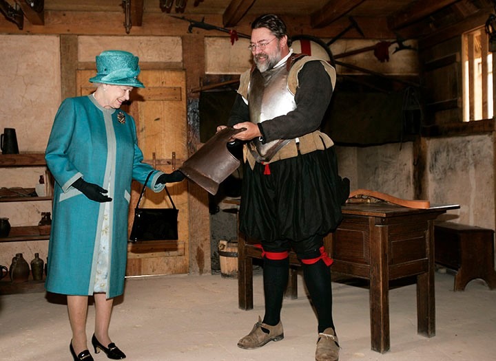 Queen Elizabeth II examines a piece of armor. Photo by Steve Heiber, Associated Press/pool.